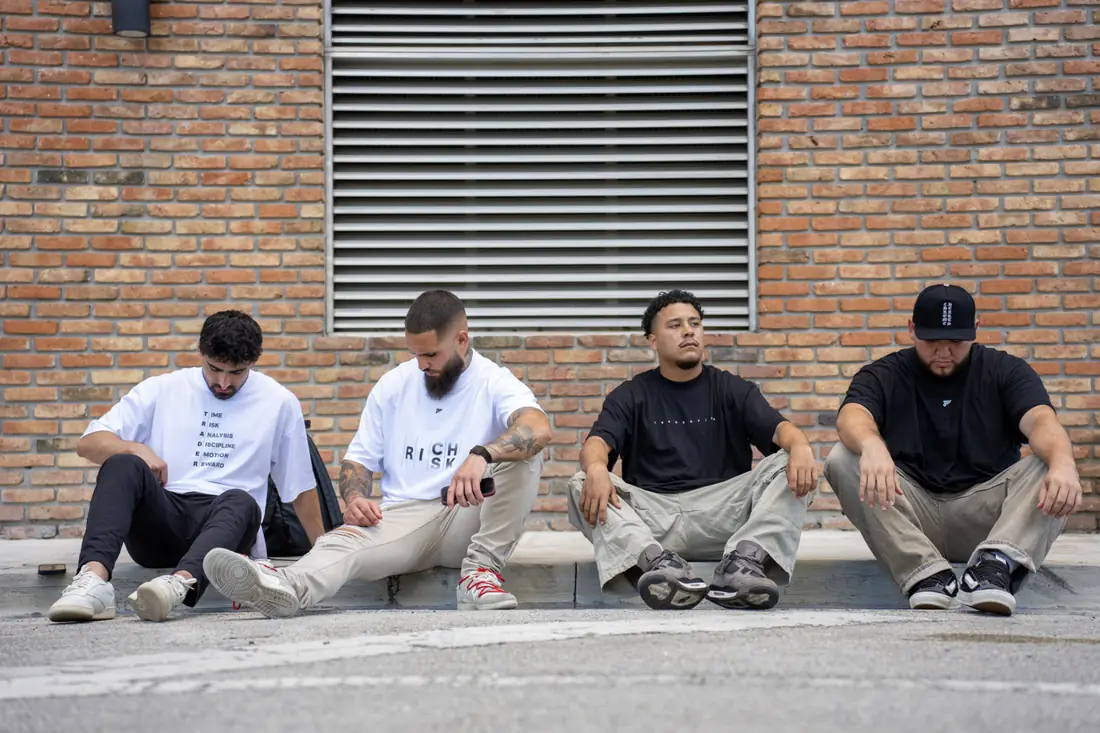Traders wearing Trader Fits oversized tees and hoodies